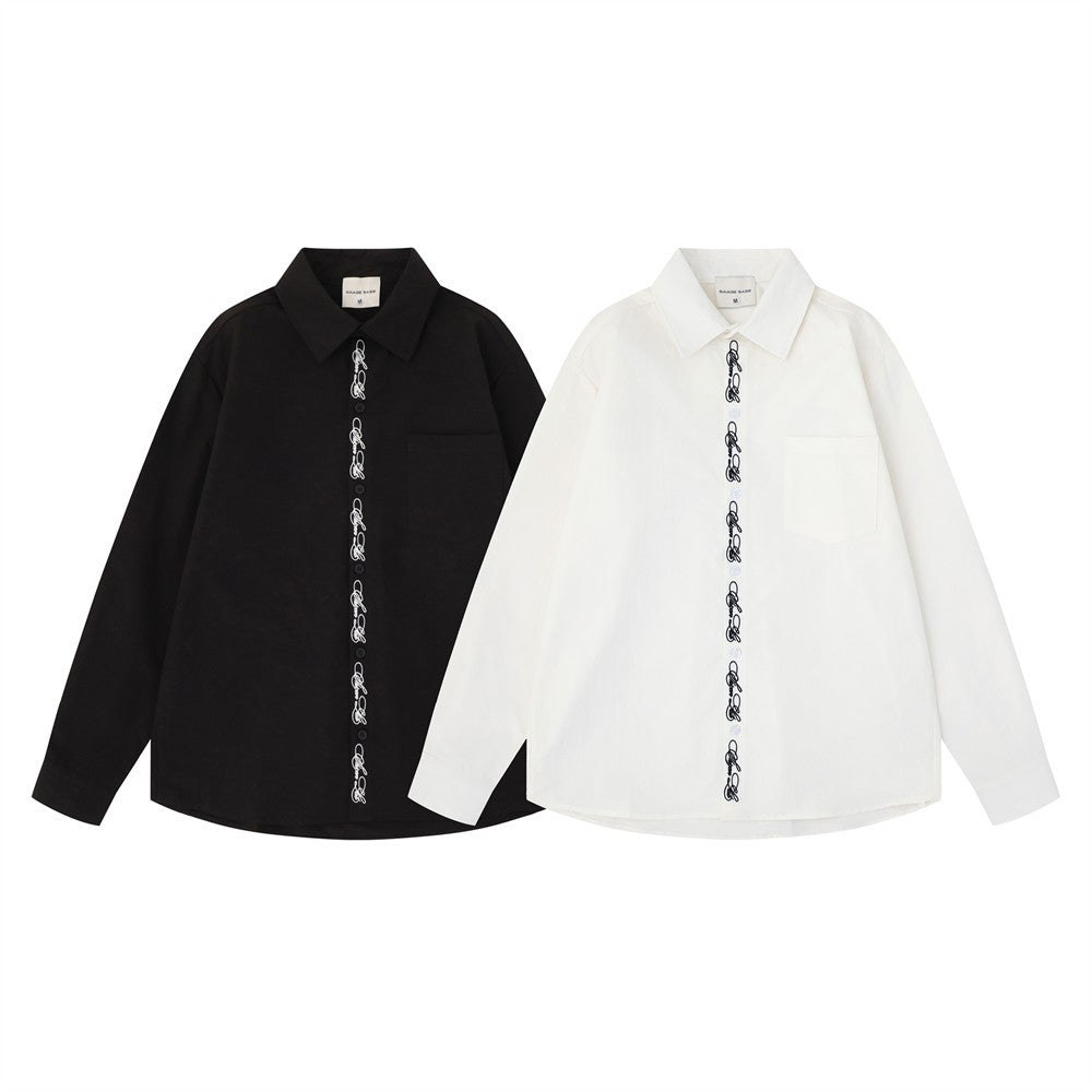 Black and white oversized long sleeve button-down shirts with script embroidery down the placket