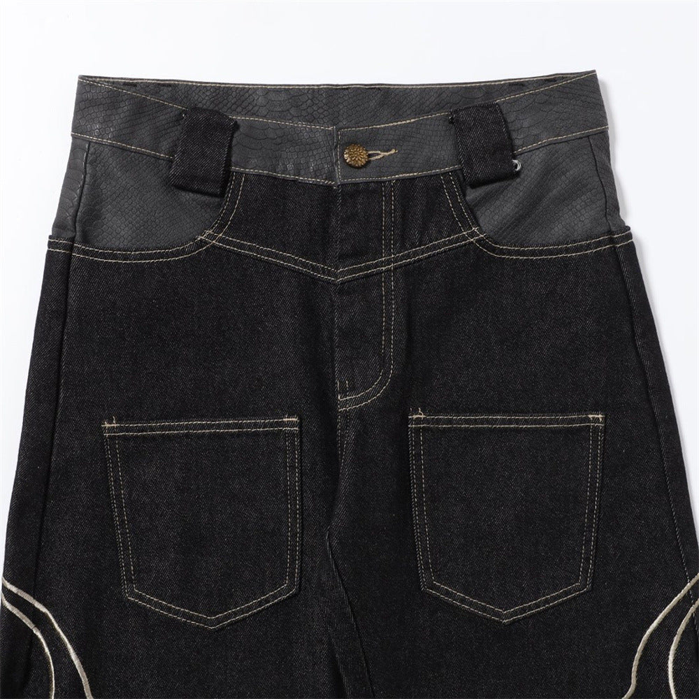 Close-up of the front waistband and pocket area on black denim jeans