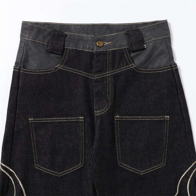 Close-up of the front waistband and pocket area on black denim jeans