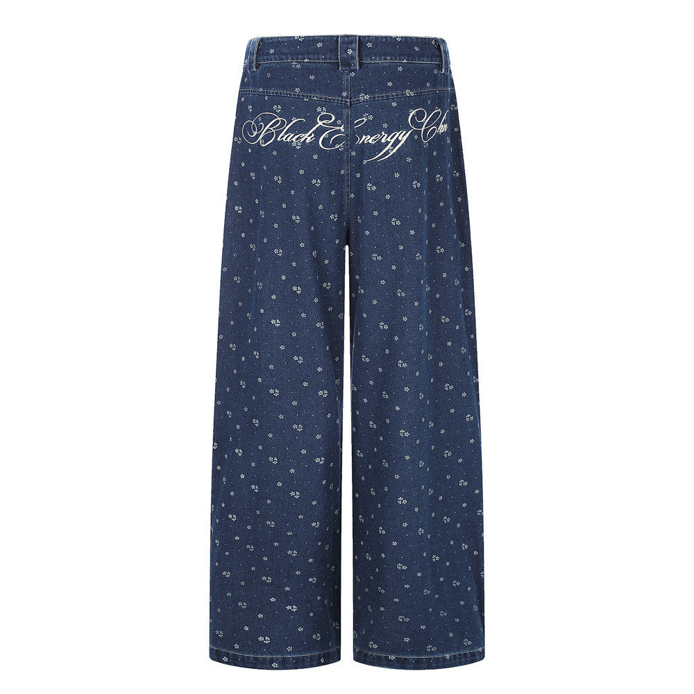 Back view of dark blue wide-leg jeans with floral print and script embroidery across the waistband