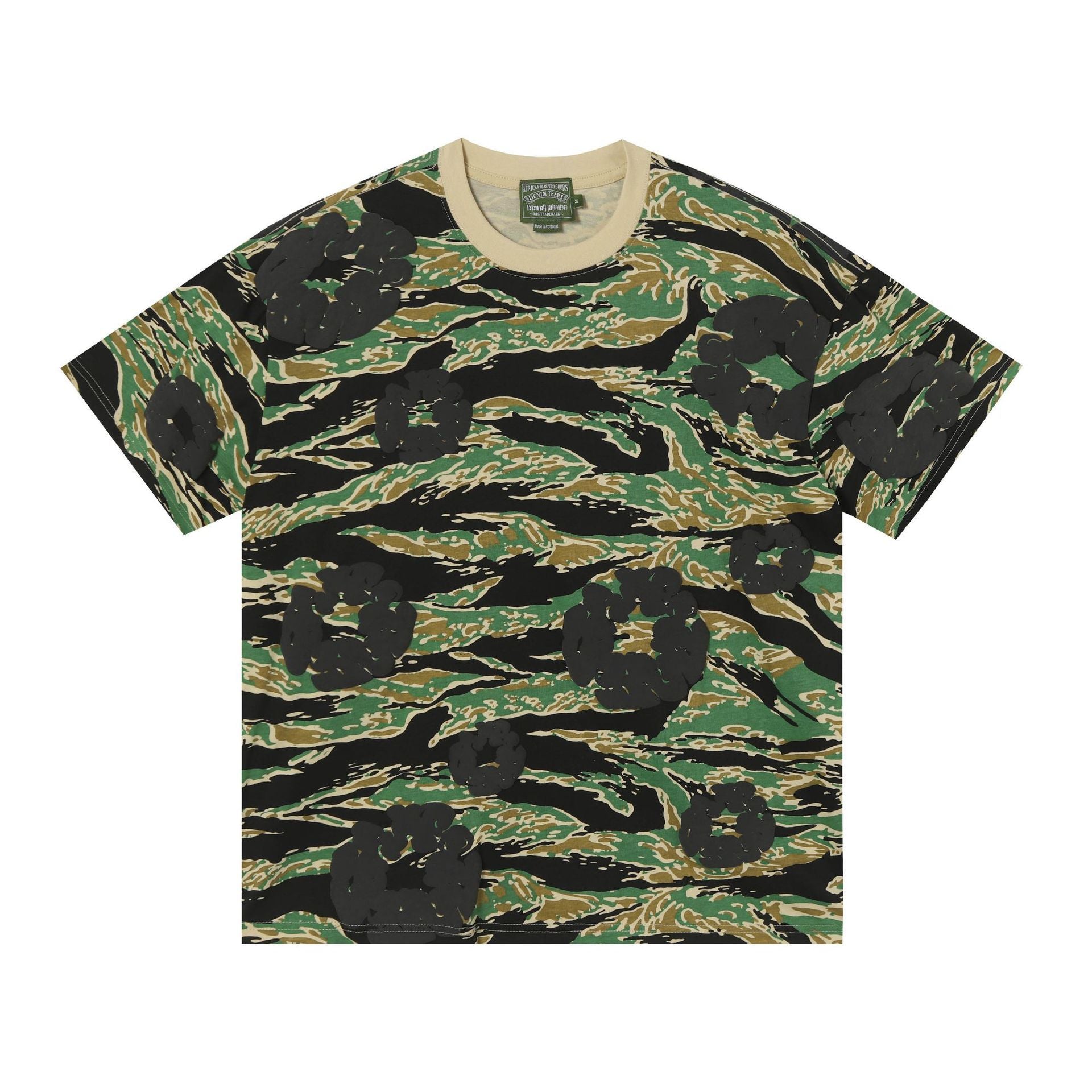 Denim Tears green tiger stripe camouflage all-over print cotton T-shirt with beige ribbed crew neck, laid flat on white background