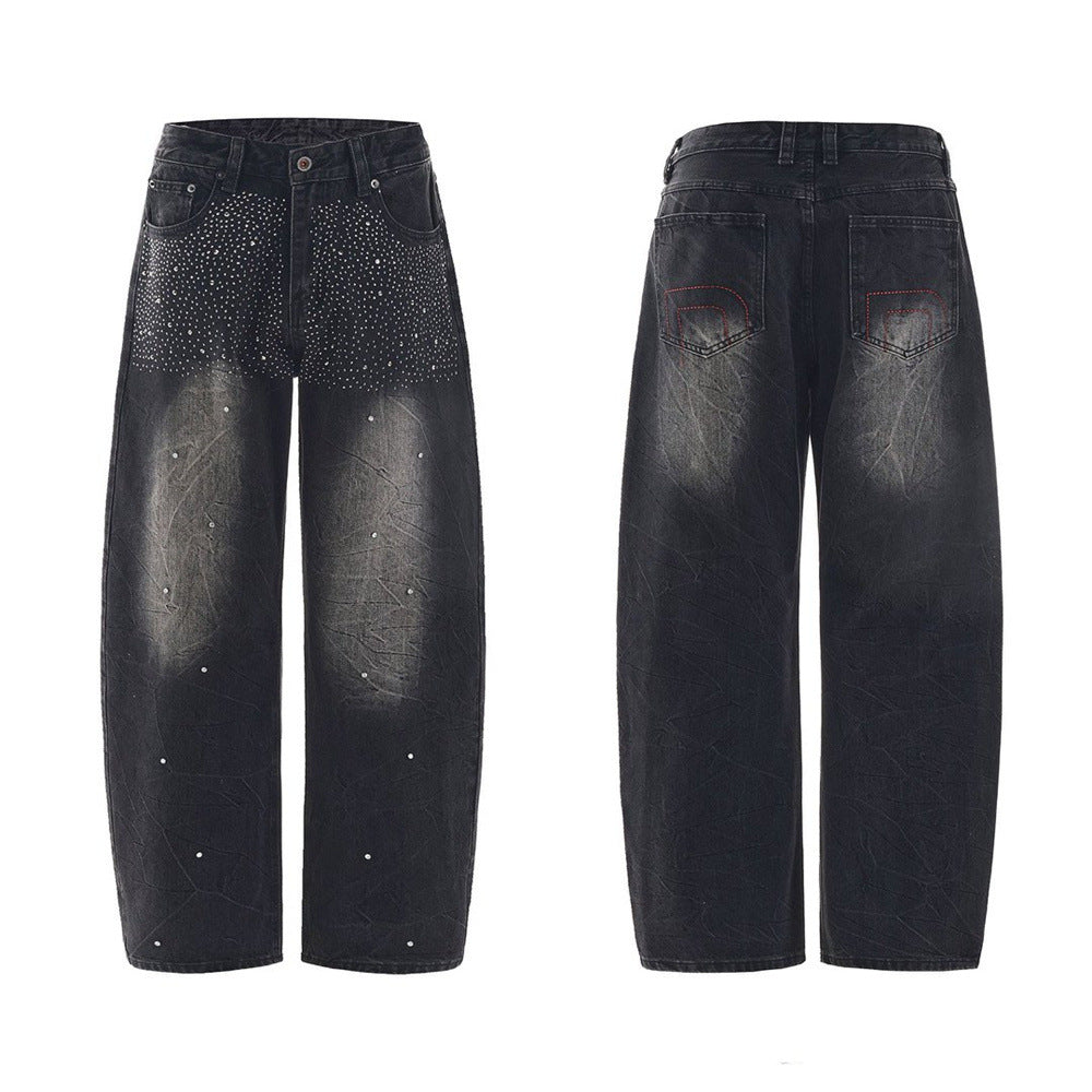 Men's washed black wide-leg baggy jeans with rhinestone embellishment on upper front panel and distressed crinkle denim textu