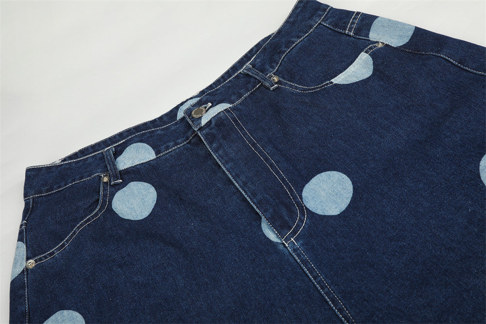 Top section of dark wash jeans with belt loops and polka dot print