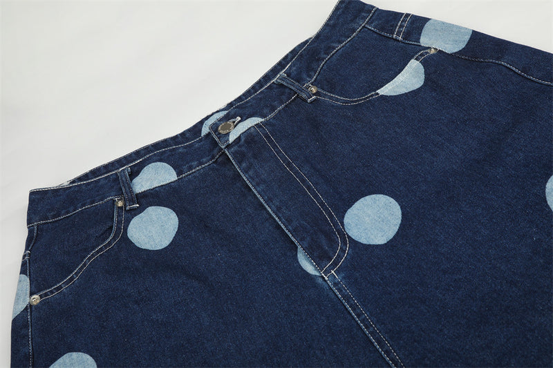 Top section of dark wash jeans with belt loops and polka dot print