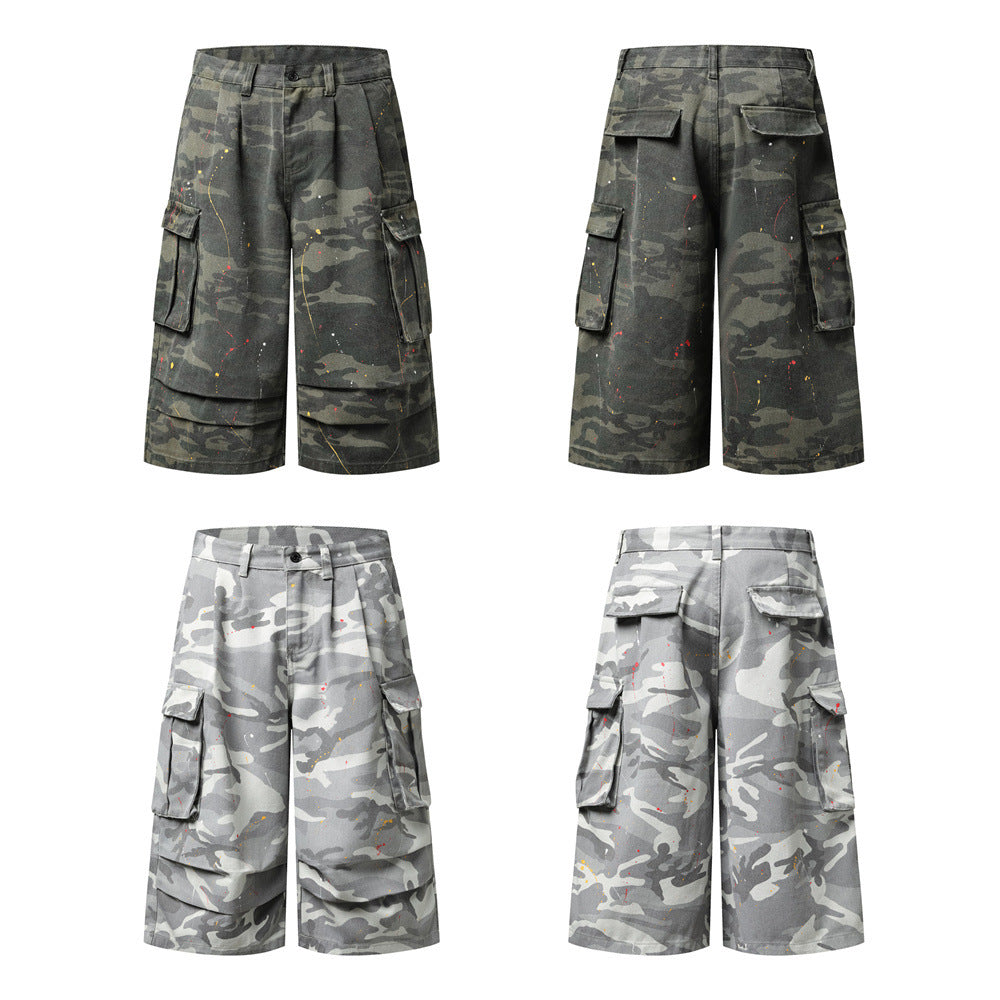 Men's camouflage cargo shorts with paint splatter detailing, multiple flap pockets, and wide straight-leg cut in camo green a