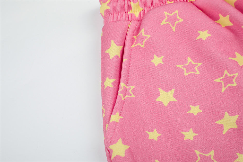 Close-up of pink star print sweatpants side pocket seam and fabric texture