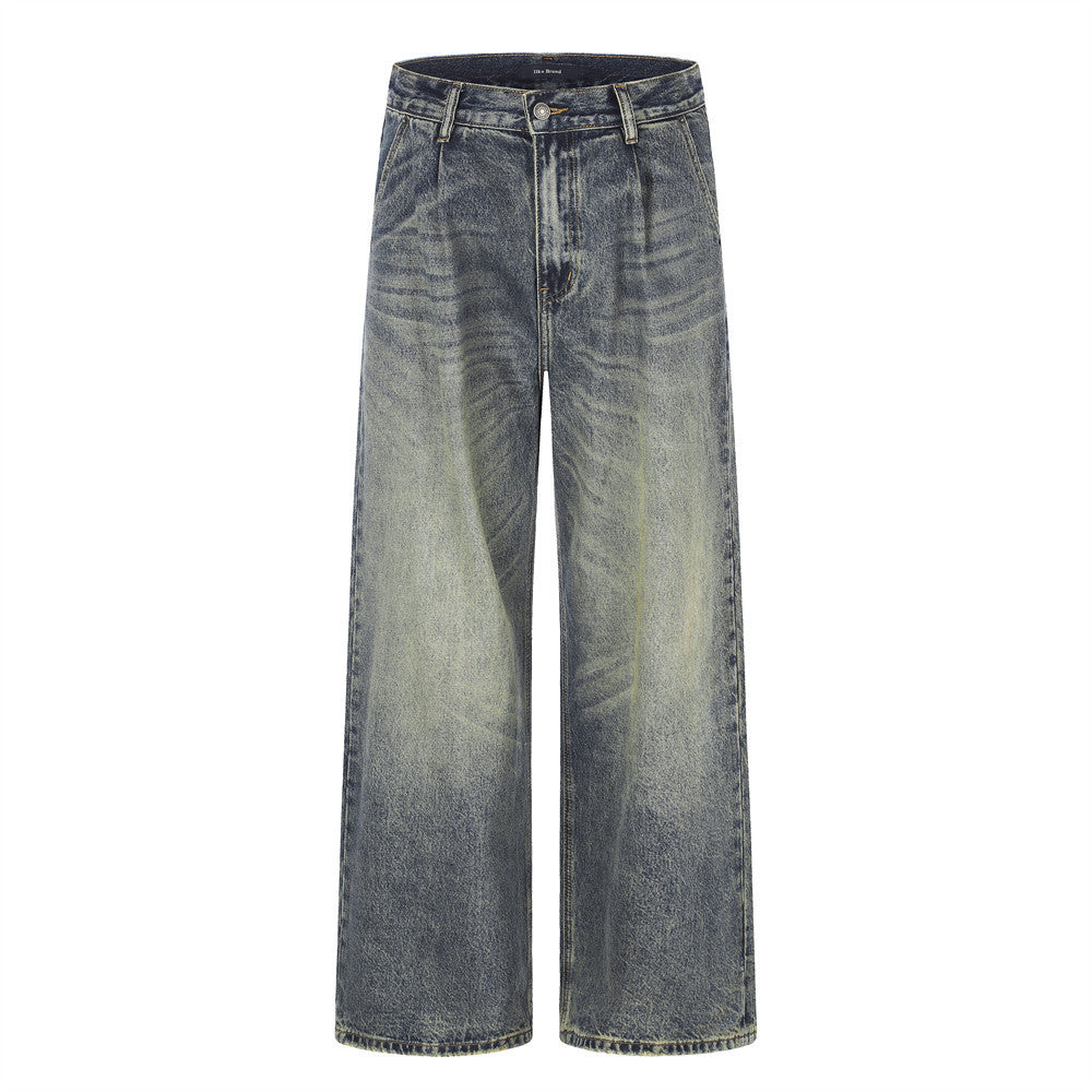 Men's wide-leg vintage washed distressed denim jeans in faded blue with yellow-ochre wash and pleated front