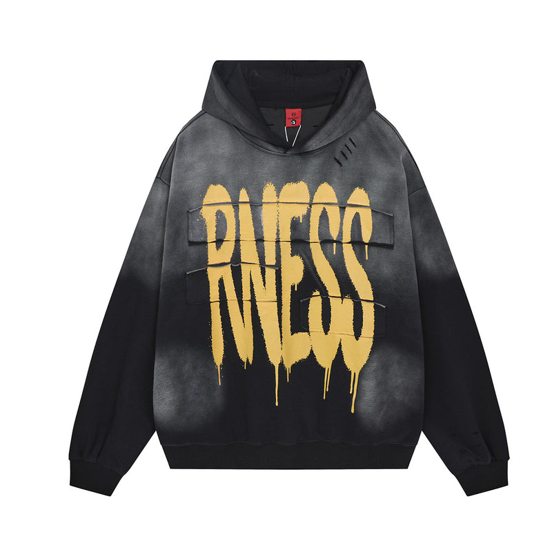 Oversized graffiti print washed distressed hoodie in washed black with gold drip lettering, front view