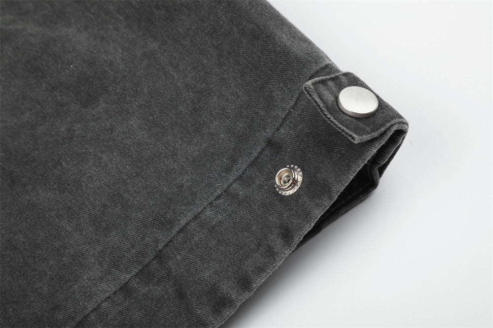 Close-up of black jacket sleeve cuff with snap button tab