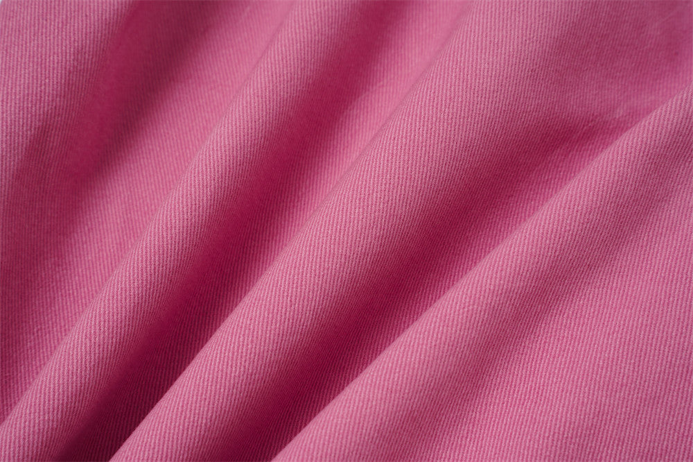 Close-up of rose pink woven fabric texture with soft folds