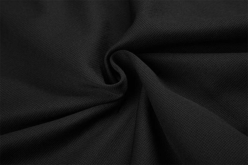 Close-up of black woven fabric with a twisted fold detail