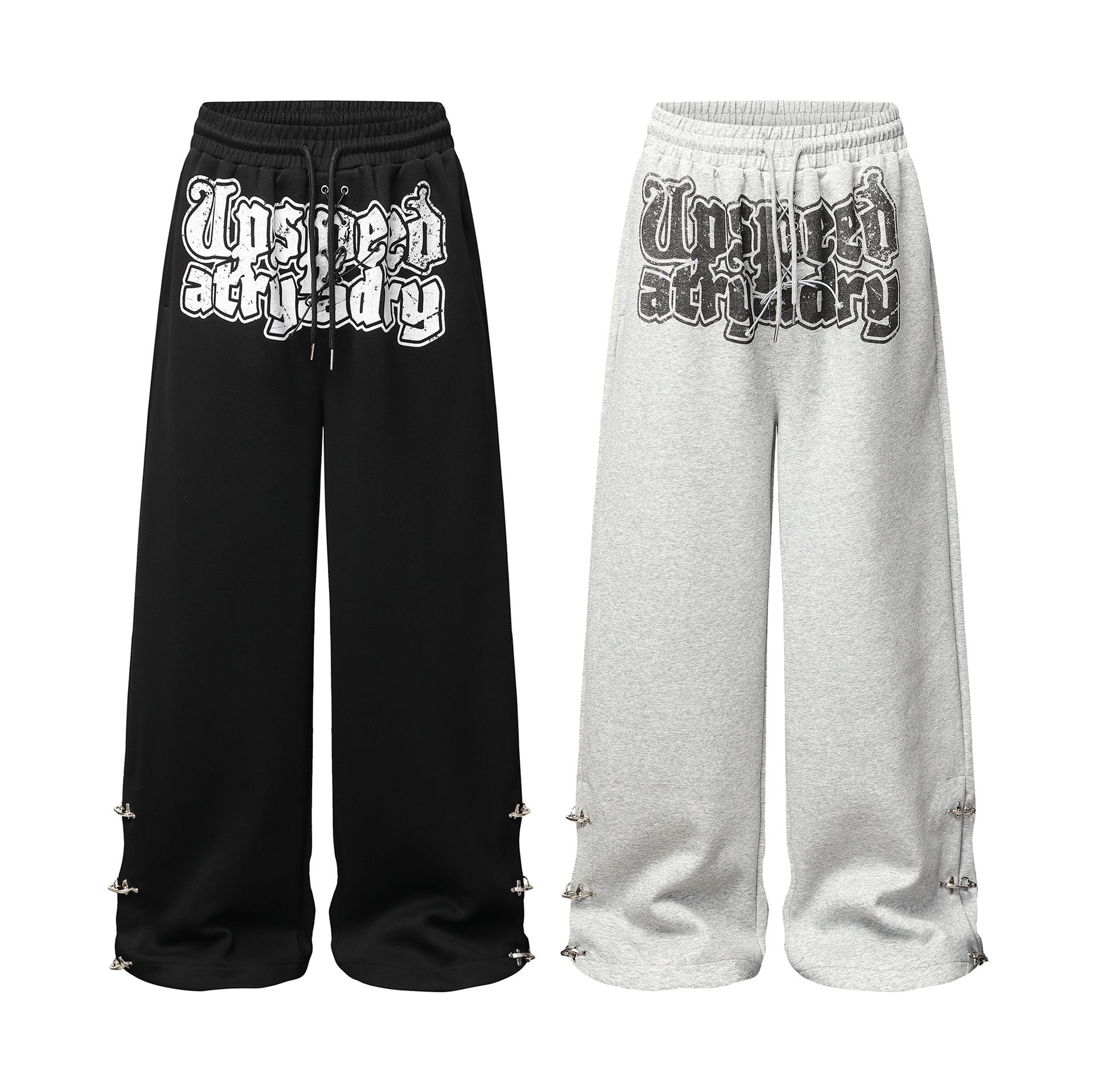 Pantalon de survêtement à jambes larges avec graphisme graffiti et ourlet orné de détails métalliques