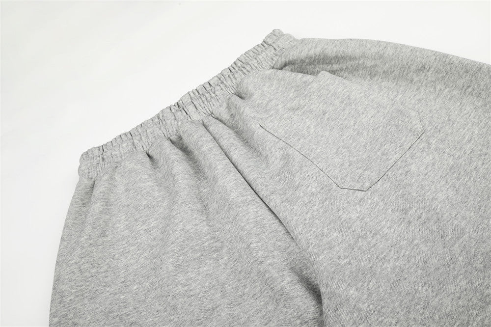 Close-up of gray sweatpants back pocket and elastic waistband