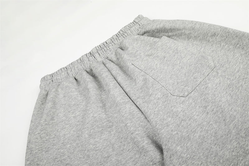 Close-up of gray sweatpants back pocket and elastic waistband