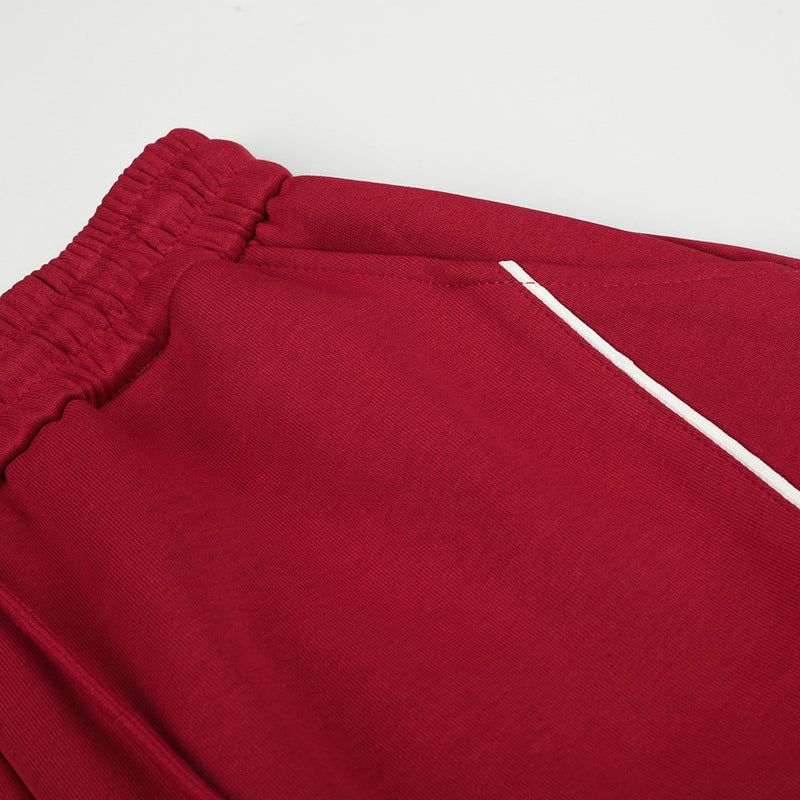 Pantalon de jogging large – Motif patte et coutures courbes rouges
