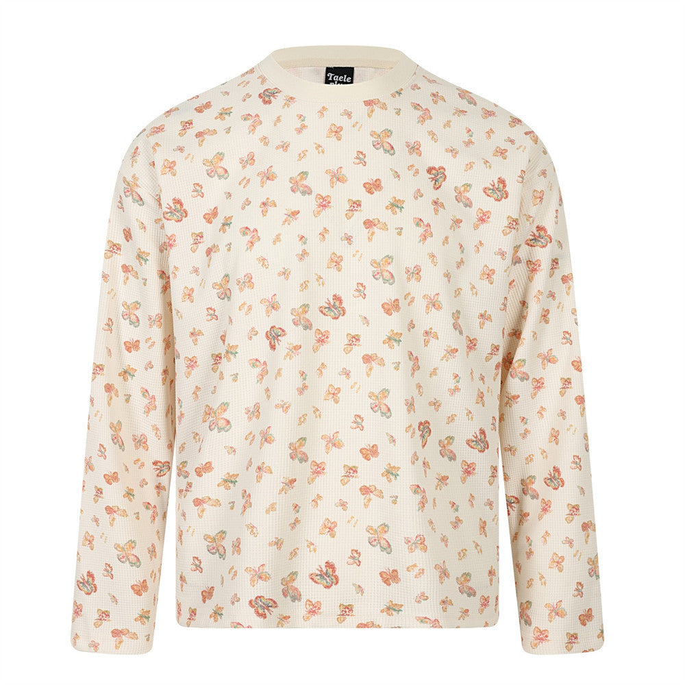 Cream waffle knit long sleeve tee with all-over scattered butterfly print in coral, peach, and sage tones, relaxed boxy fit w