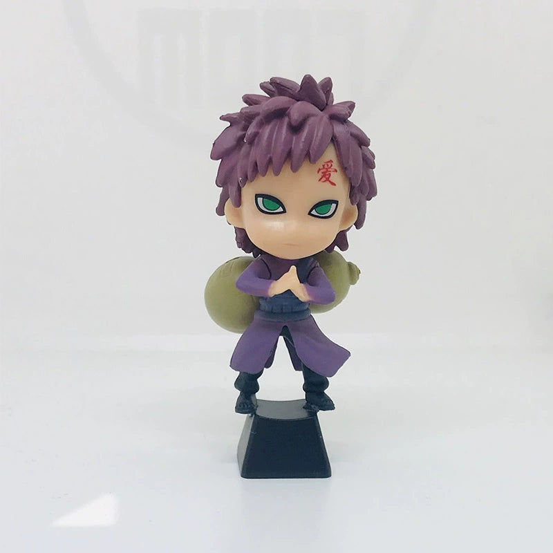 This chibi-style figurine, featuring purple spiky hair, green eyes, and a kanji on the forehead, evokes Naruto characters. Dressed in a purple outfit with a large sack on their back, it&