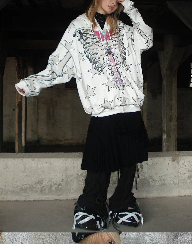Sporting Seakoff's Gothic Skeleton Star Hoodie, a full-zip hoodie adorned with a skeleton print and star pattern, paired with a black skirt and chunky black-and-white sneakers, this individual embodies gothic allure in an industrial-style space.