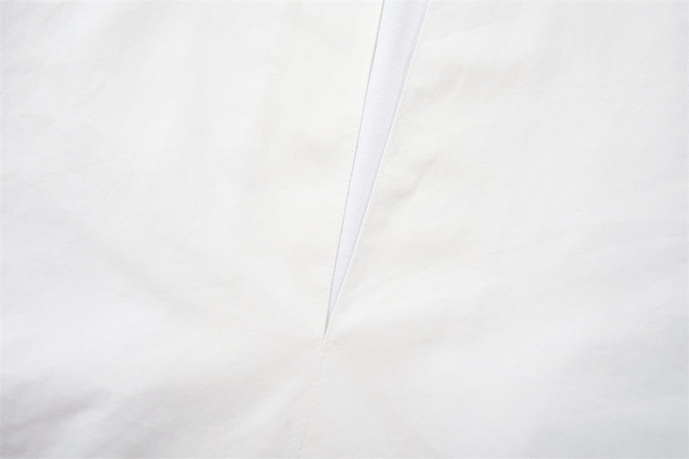 Close-up of the white V-neck placket on the pullover shirt