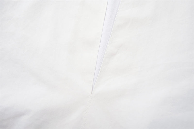Close-up of the white V-neck placket on the pullover shirt