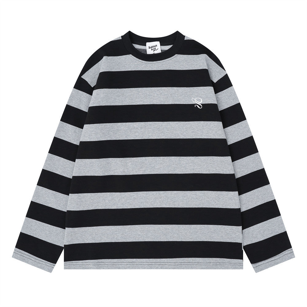 Front view of black and gray striped oversized crew neck long sleeve shirt with small chest logo