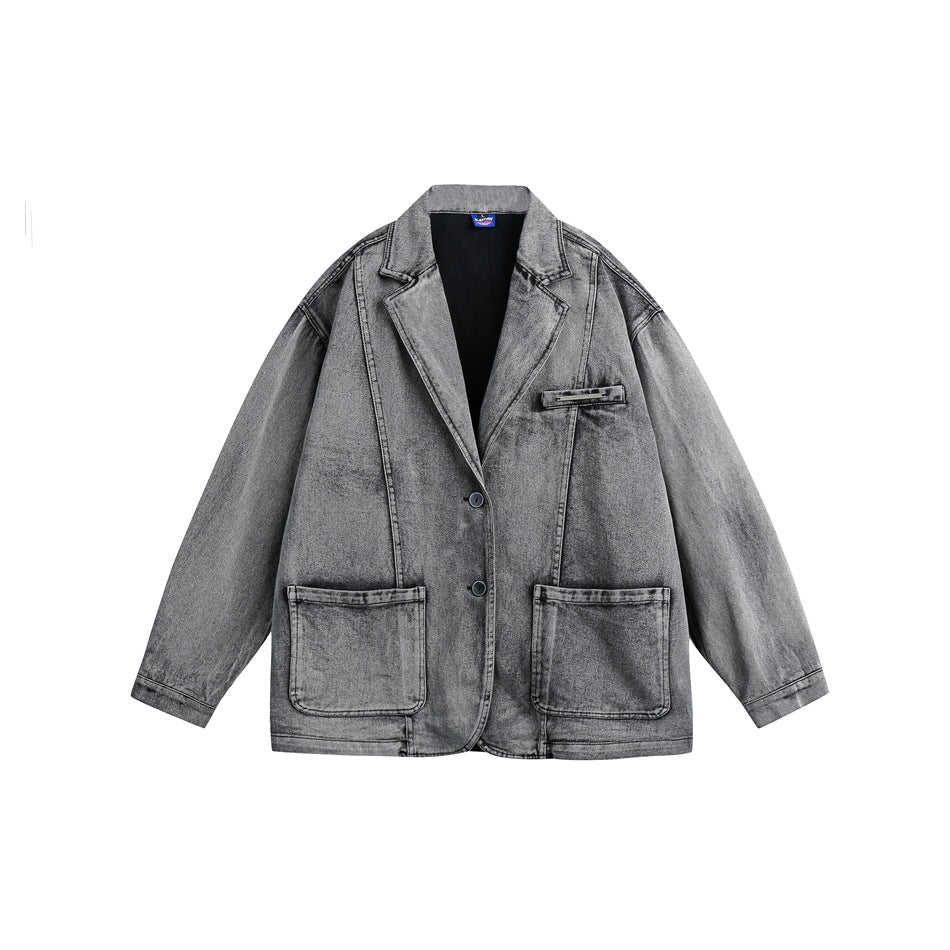 Oversized washed grey-black denim blazer jacket with notched lapel and large patch pockets, laid flat on white background