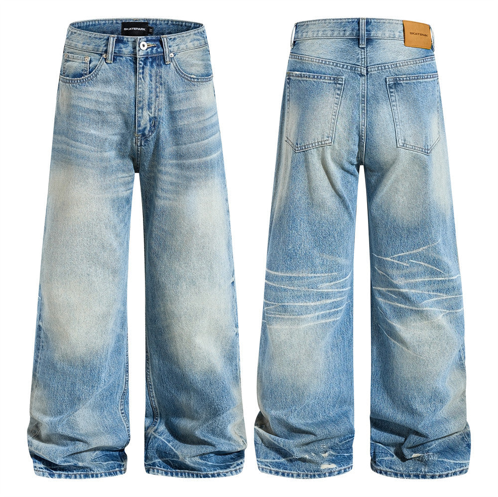 Men's wide-leg baggy jeans in vintage-washed light blue denim, front and back view showing gradient fading and distressed det