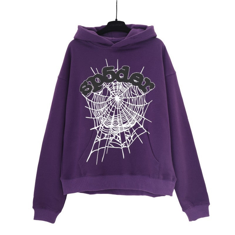 The Bold Purple Sp5der Hoodie features an eye-catching black and white spiderweb graphic with &quot;sinner,&quot; embodying streetwear fashion. Presented on a hanger against a plain white background, it&