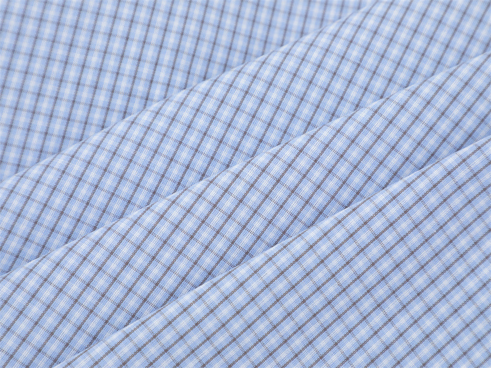 Close-up of the light blue plaid fabric texture and fine check pattern
