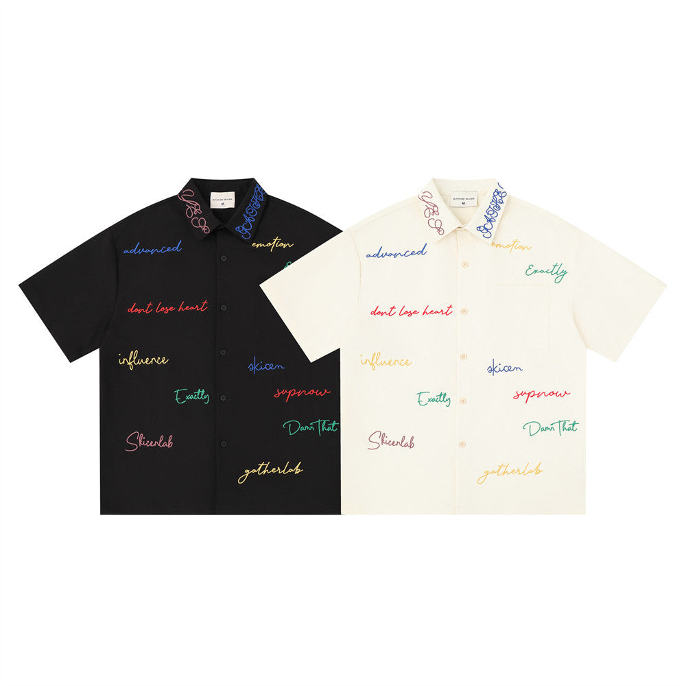 Short sleeve button-down shirt in black and cream with multicolor script embroidery, front view