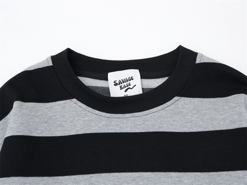Close-up of black and gray striped crew neck collar with woven brand tag