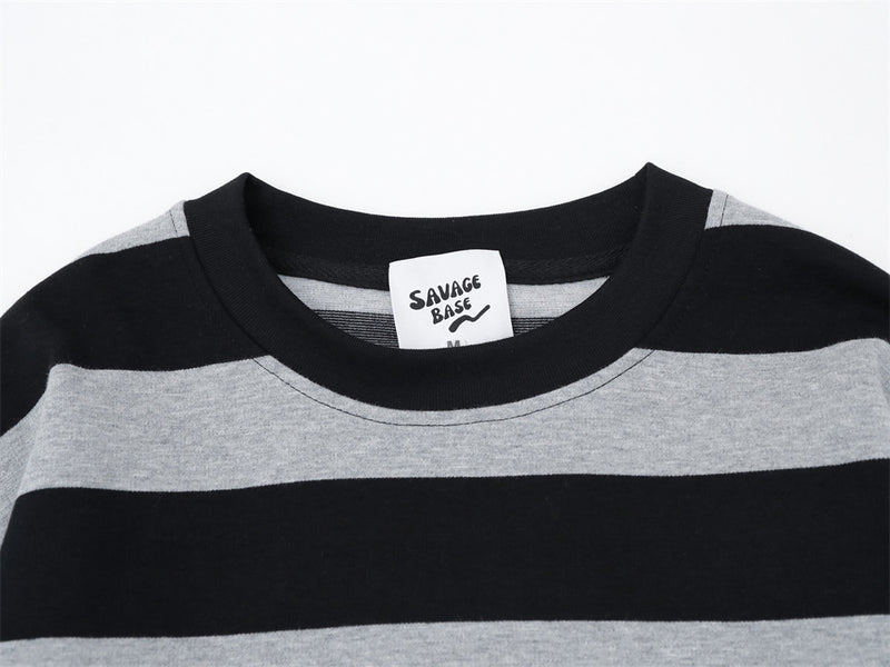 Close-up of black and gray striped crew neck collar with woven brand tag