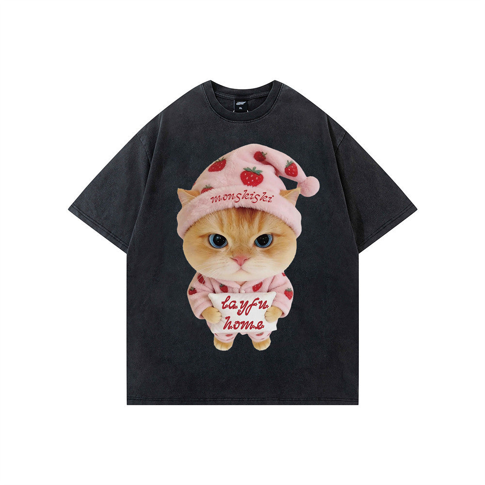 Oversized short-sleeve cotton graphic tee with cute cat in strawberry pajamas print, shown in white and washed black