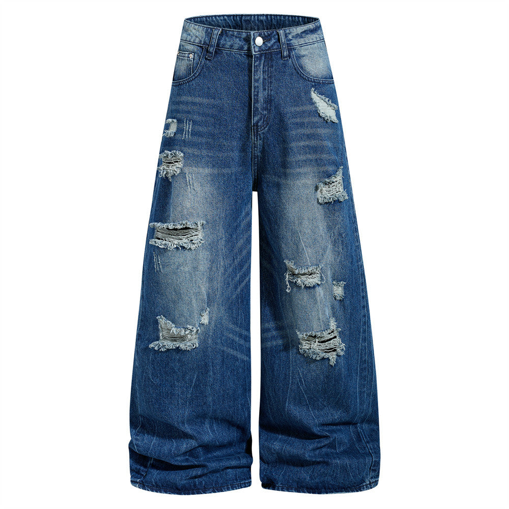 Men's wide-leg baggy ripped jeans in medium blue washed denim with heavy distressing and frayed tear details, front and back