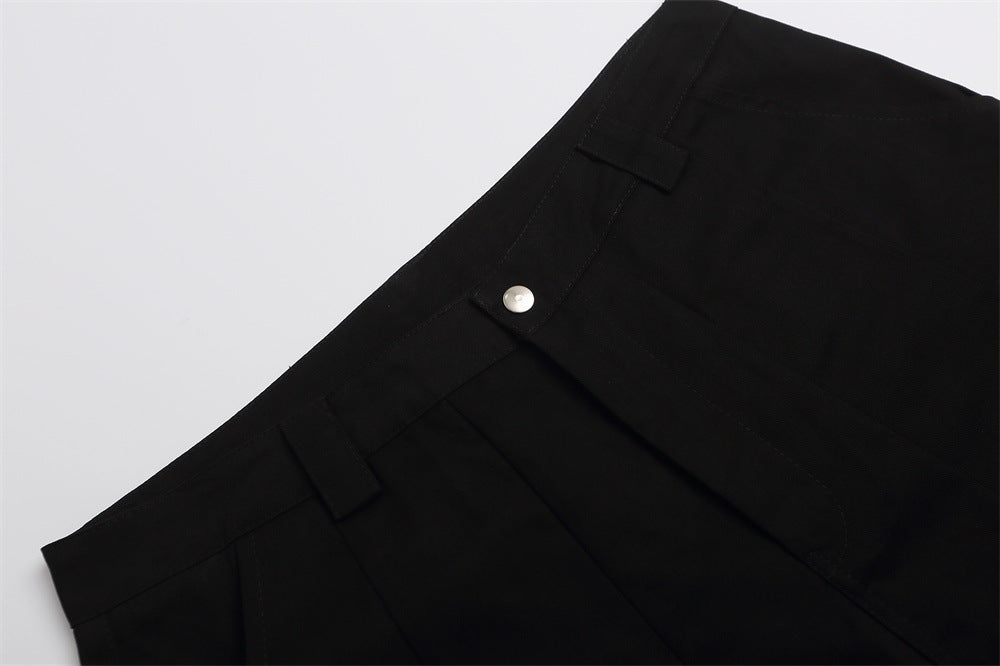 Close-up of black shorts waistband with snap button and belt loops
