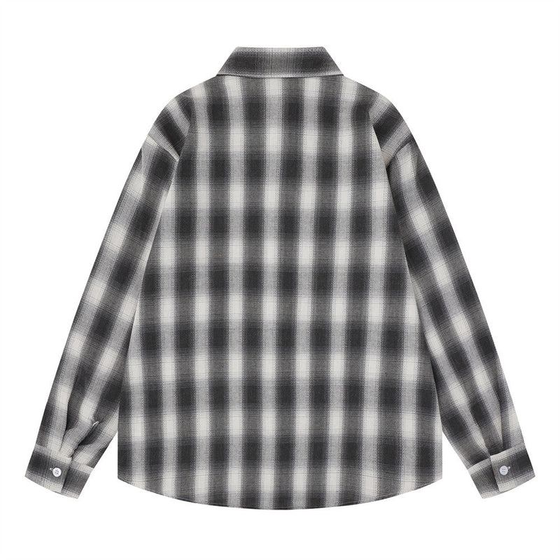 Back view of a black and white plaid long sleeve shirt with plain yoke and curved hem