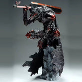 The Legend of the Golden Warrior – Berserk Guts L Version is a battle-damaged bloodstained PVC anime figure by Berserk, showcasing an intricately detailed warrior in dark armor with red accents, a large sword on their shoulder, and a flowing cape posed vibrantly atop a textured rock base.