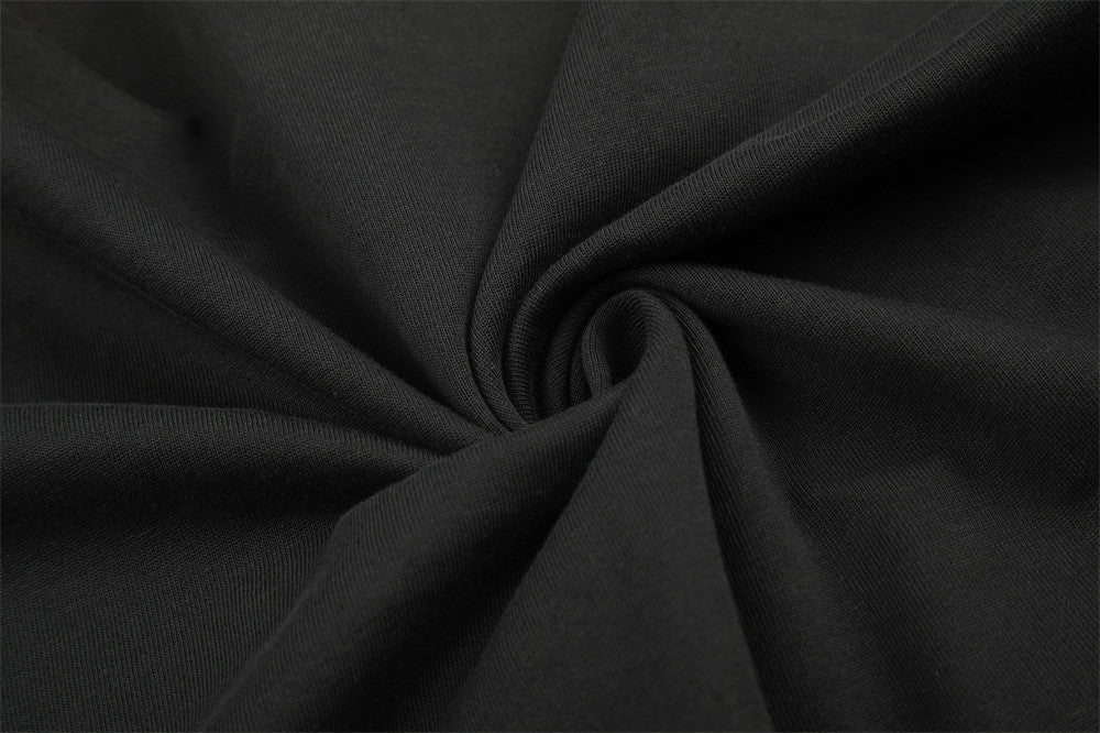 Close-up of black knit fabric texture with gathered fold