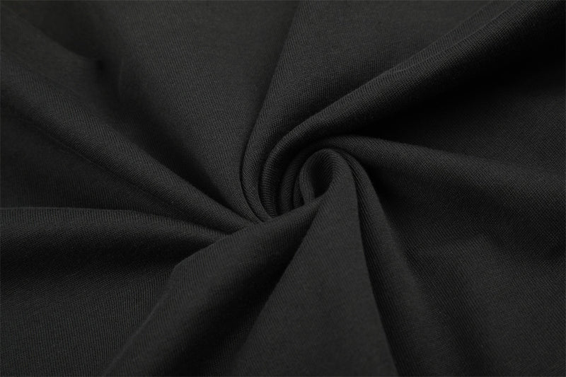 Close-up of black knit fabric texture with gathered fold