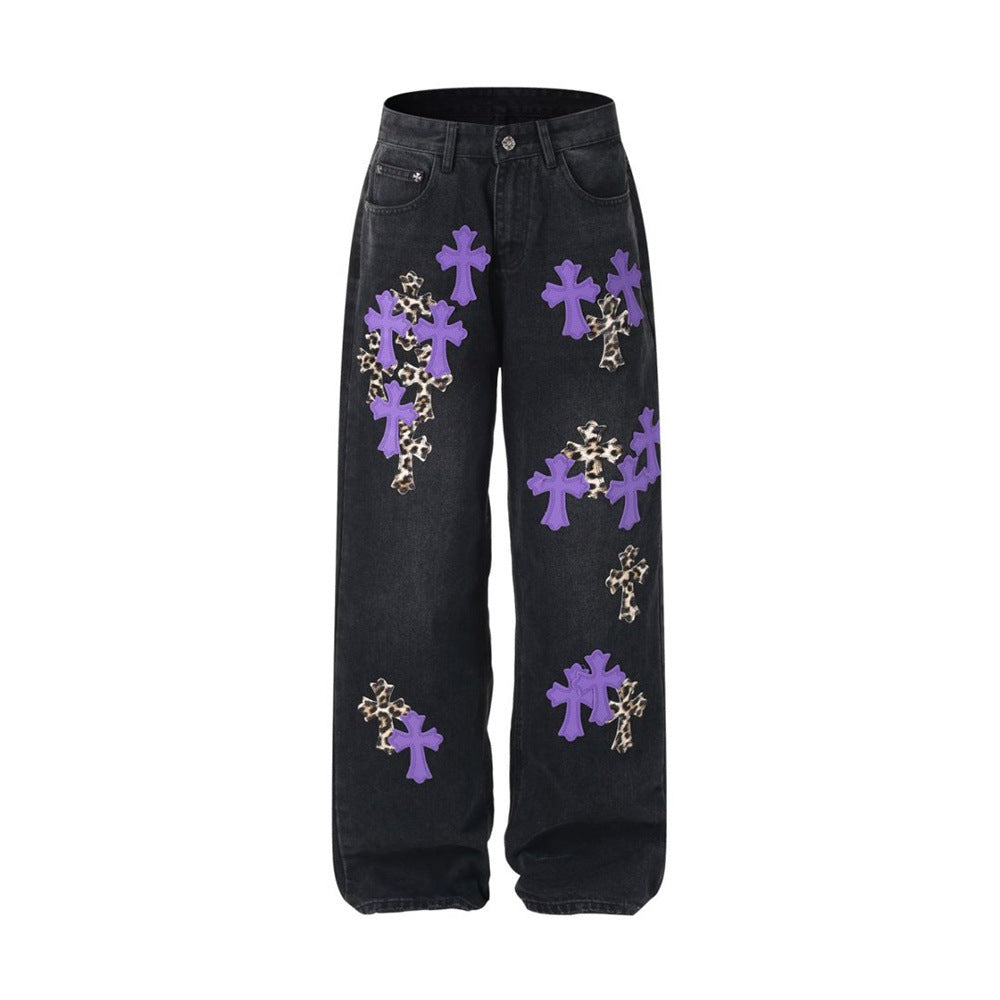 Black wide-leg jeans with purple and leopard cross patches, front flat lay