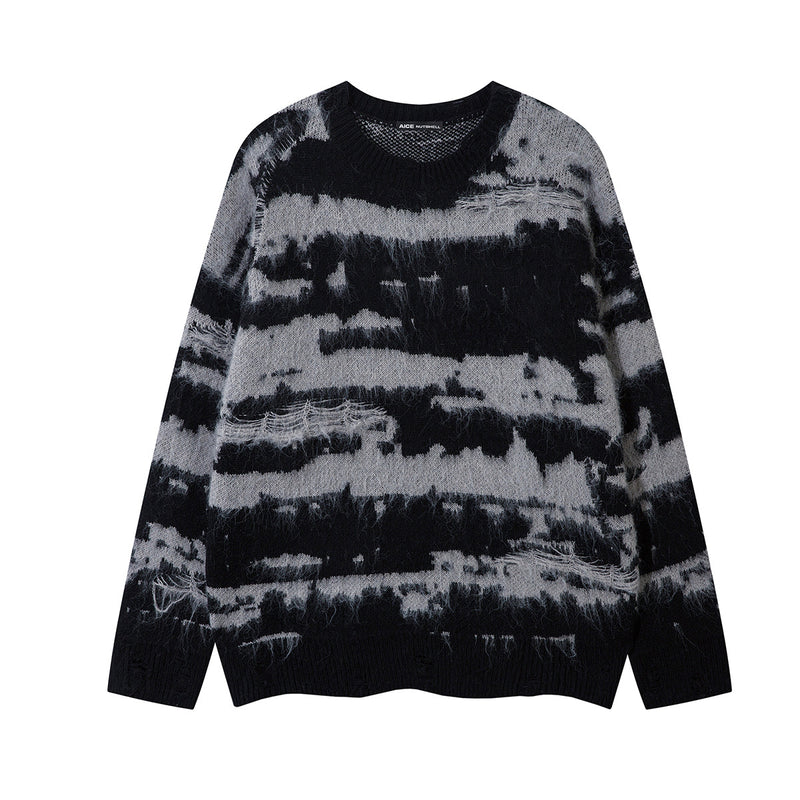 Front view of an oversized black and gray striped jacquard knit sweater with a crew neckline