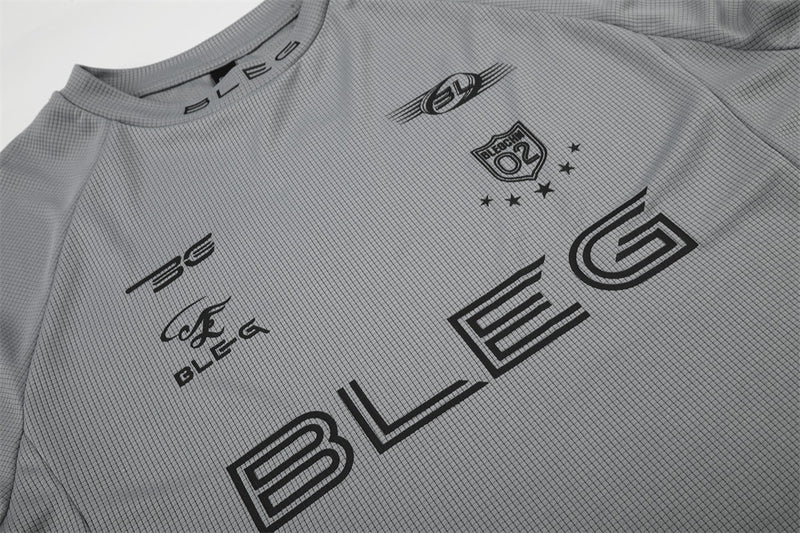 Close-up of gray shirt front with black racing logos and large BLEG print