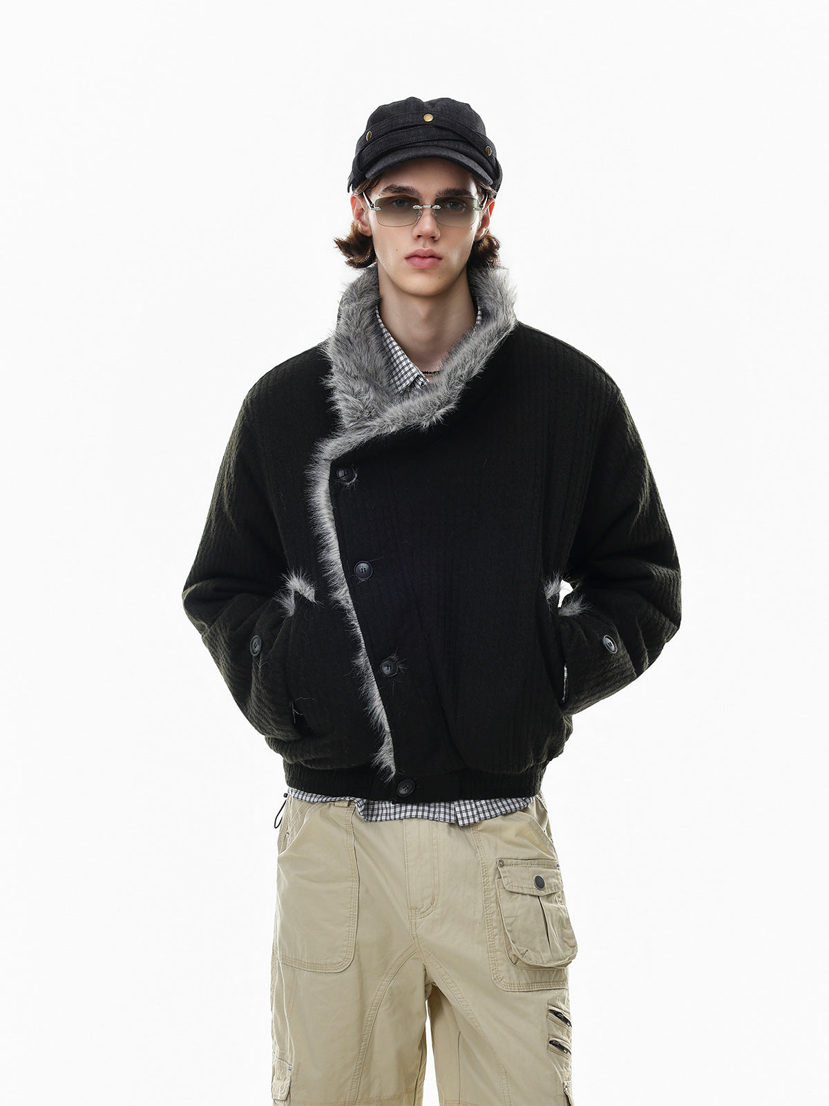 Men's black padded bomber jacket with grey faux fur collar and asymmetric button front, styled with cargo pants