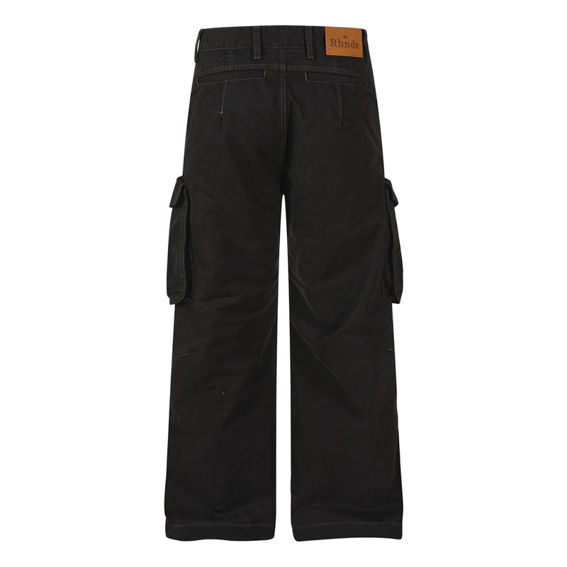 Back view of black cargo pants with cargo pockets and leather-style brand patch at waistband