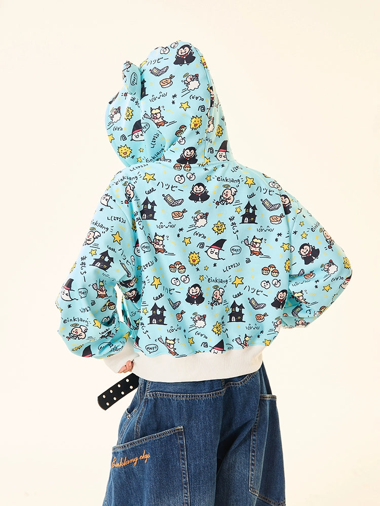 A person in a Seakoff Kawaii Cartoon Bear Hoodie, a light blue piece with adorable ears and fun cartoon print, stands with their back to the camera. It pairs seamlessly with denim pants featuring vibrant orange embroidery on the back pocket.