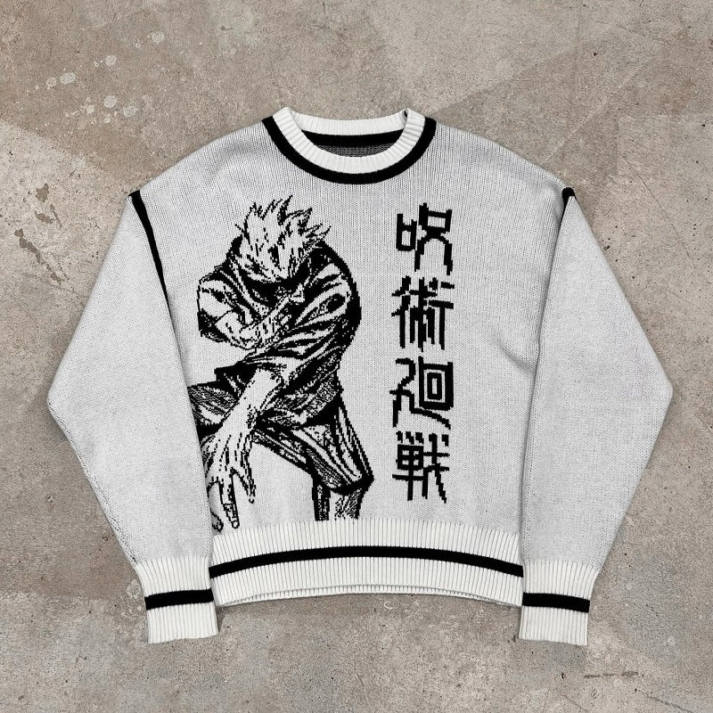 Laid flat on a concrete surface, this white knit sweater from Jujutsu Kaisen features a dynamic black and white anime illustration with Japanese text. The Premium Sukuna-Inspired Knit Sweater boasts black trim on the cuffs, neckline, and hem in a stunning Curse King Jacquard design.