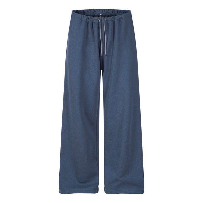 Men's baggy wide-leg track pants in slate blue with drawstring waist and back graphic crest pocket print