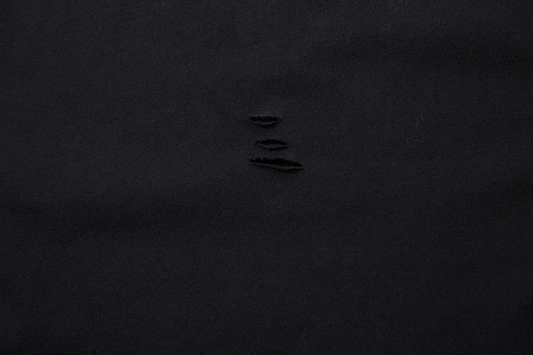 A sheet of black fabric with four small horizontal tears in the center, reminiscent of edgy anime streetwear, evokes the allure of a limited edition Death Note Long Sleeve Shirt by Death Note in black & gray gradient with distressed design and artistic hem.