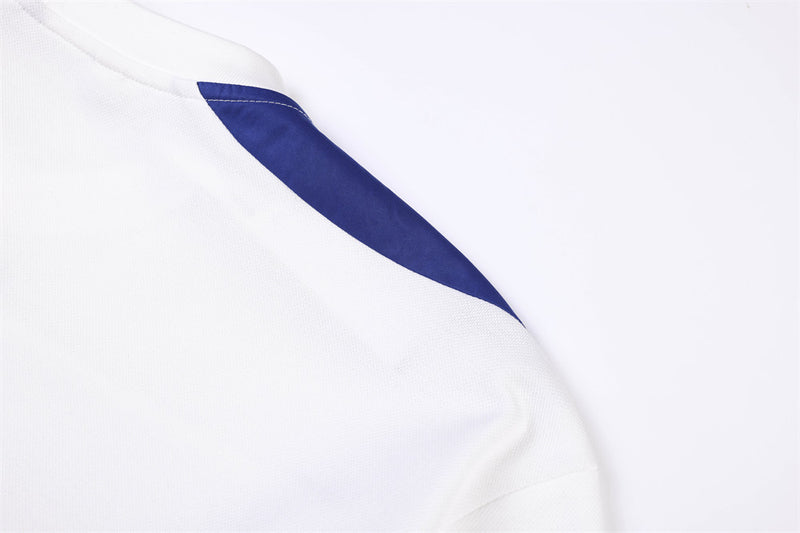 Close-up of blue shoulder panel on white jersey
