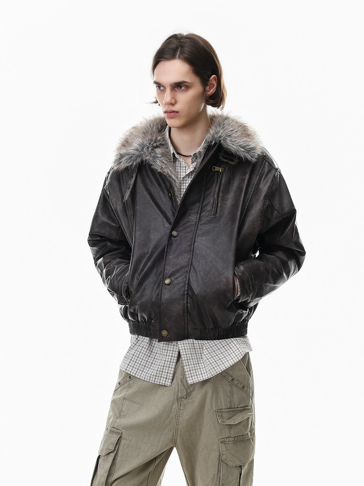 Model wearing a black faux leather bomber jacket with gray fur collar, front three-quarter view